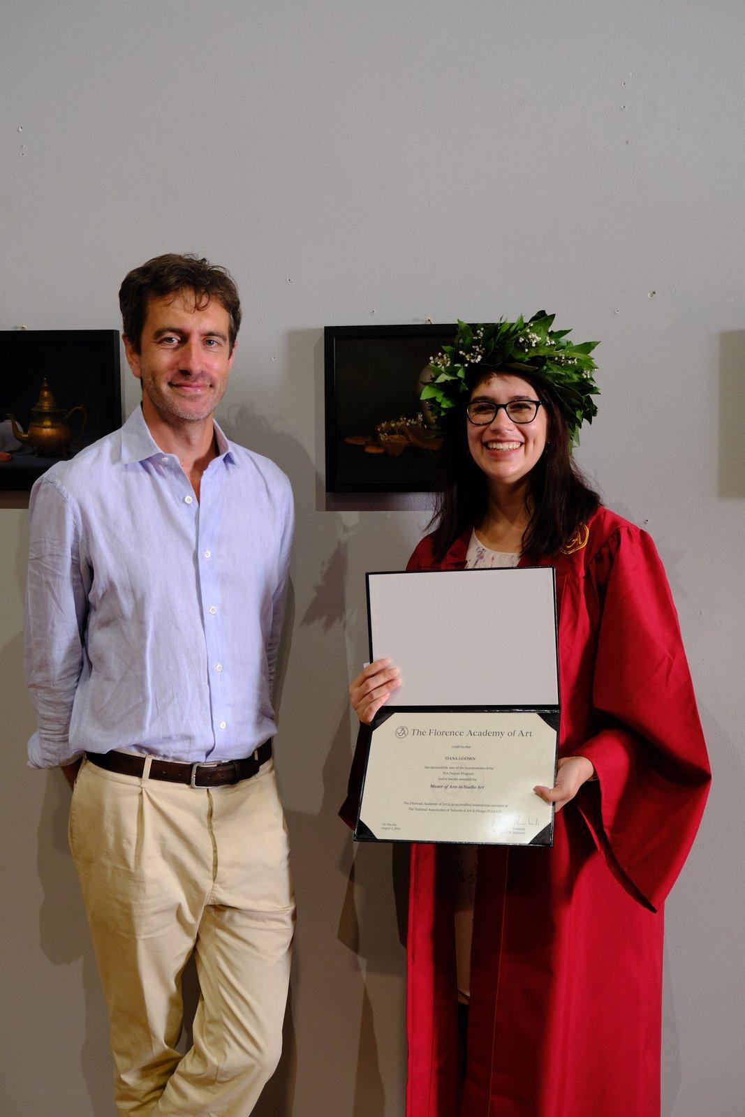 Tiana in a graduation gown and laurel wreath holding her diploma