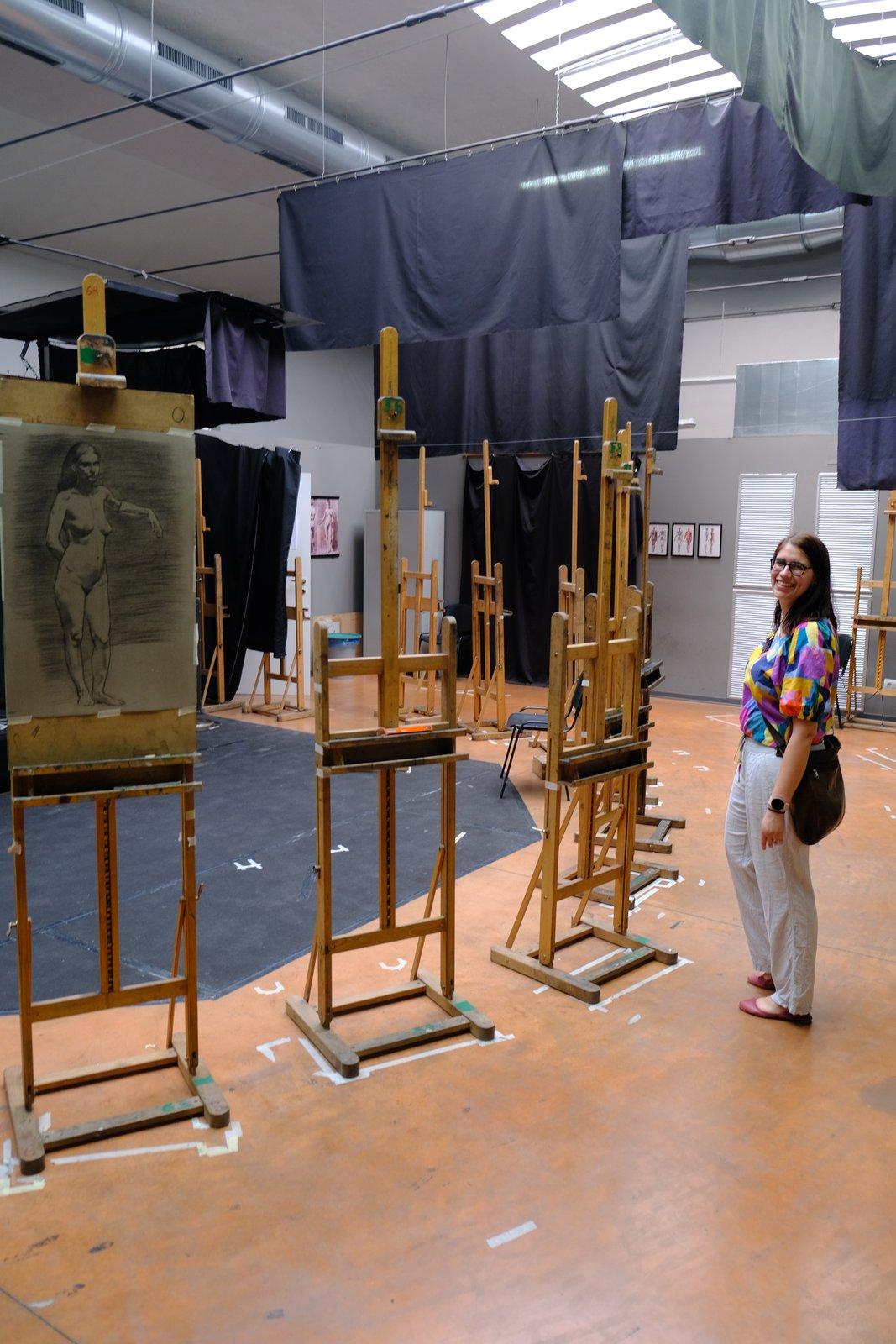 A figure drawing studio lined with easels