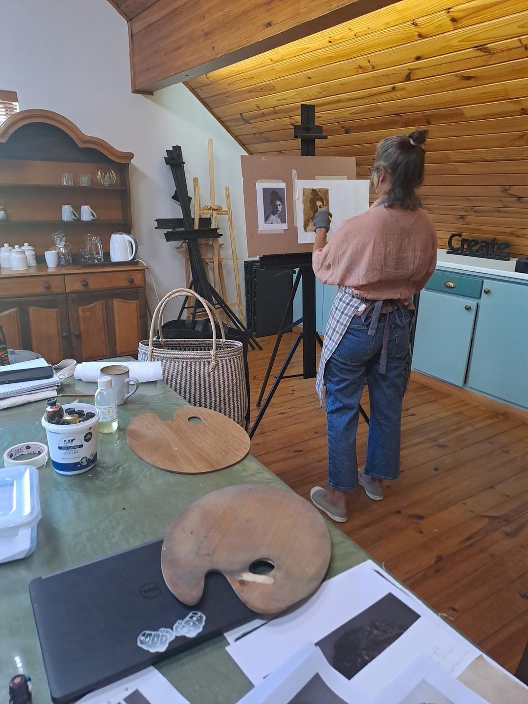 A student painting at an easel in the studio